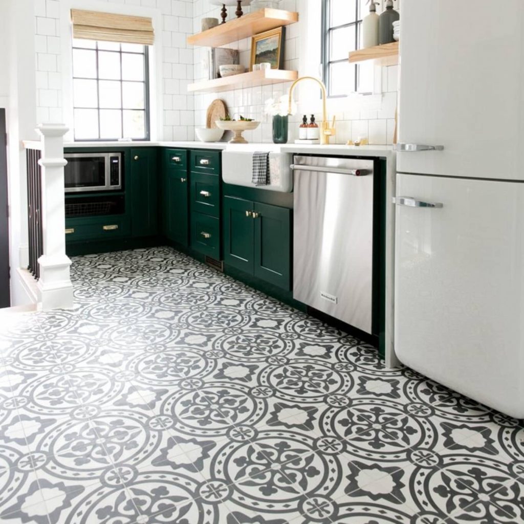 medallion style tiles in kitchen with green cabinets