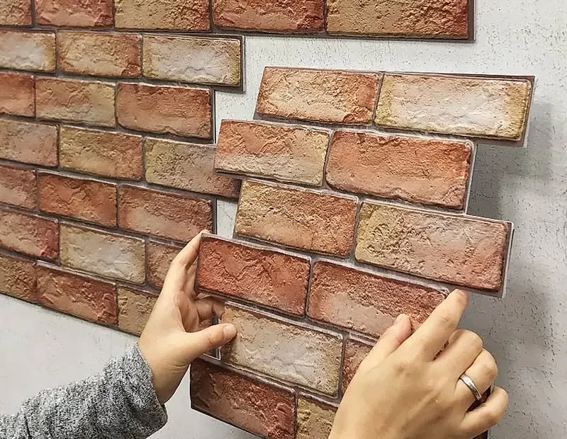 brick tiles being applied to a wall