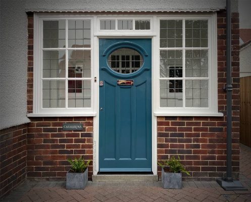 blue 1930s style door with oval window