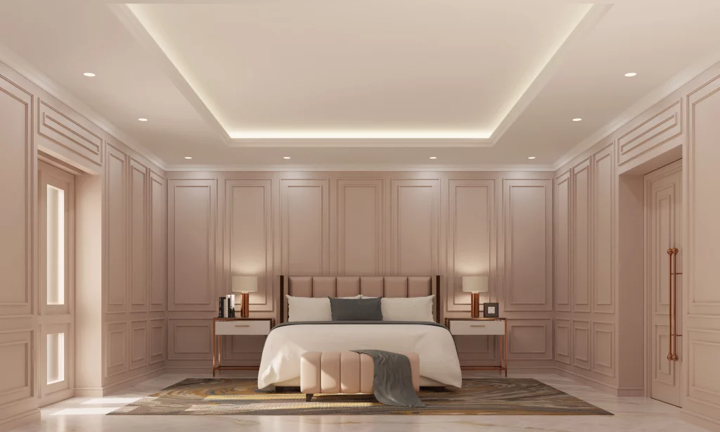 Large open bedroom with white and grey pillows with recessed light on ceiling 