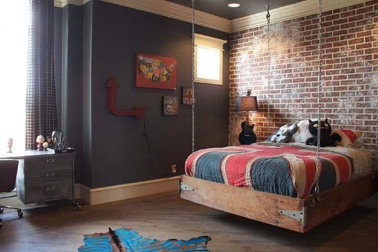 industrial style bedroom with bed elevated off floor from chains hanging from roof