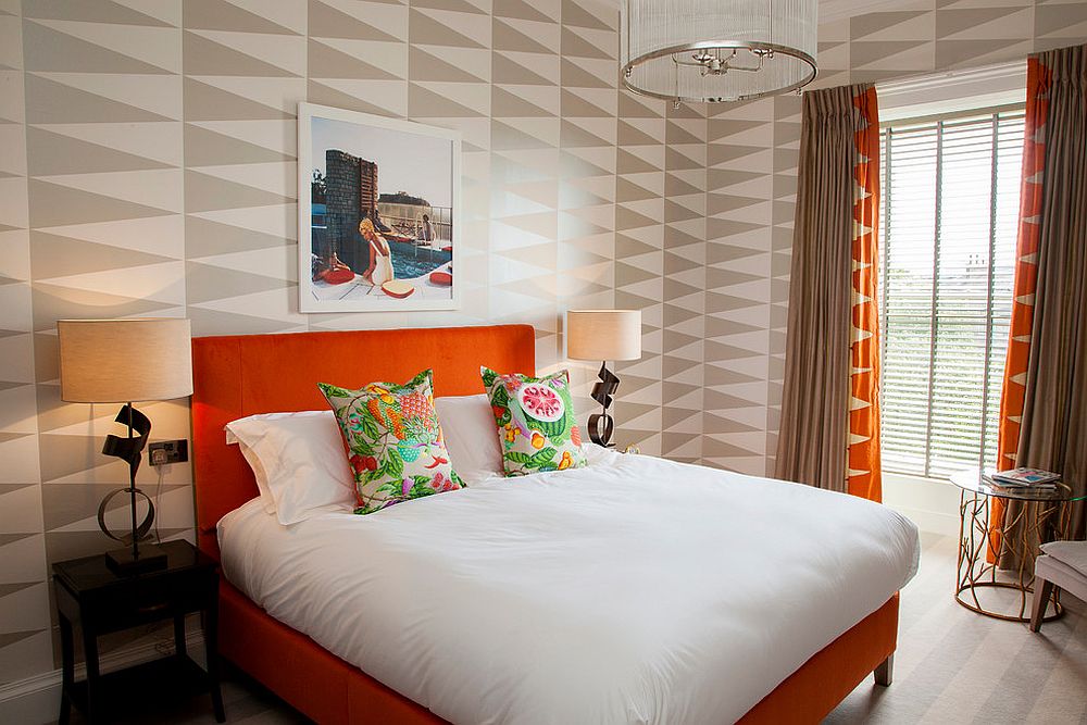geometric chevron style wall with orange bed with white bedding
