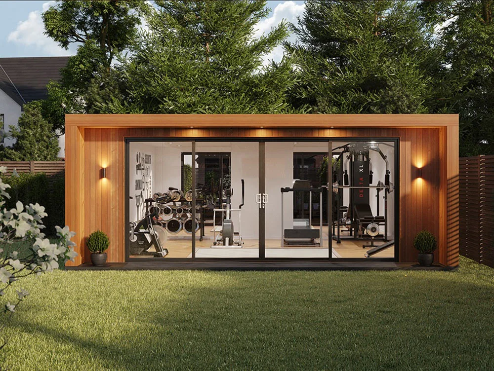 Insulated garden room with exterior lighting and large bi-folding doors. Gym idea for garden room