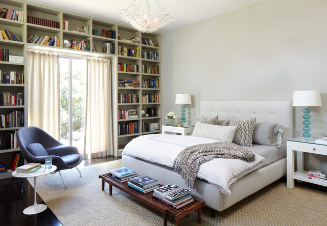 library themed bedroom. One wall filled with bookshelves and books. 