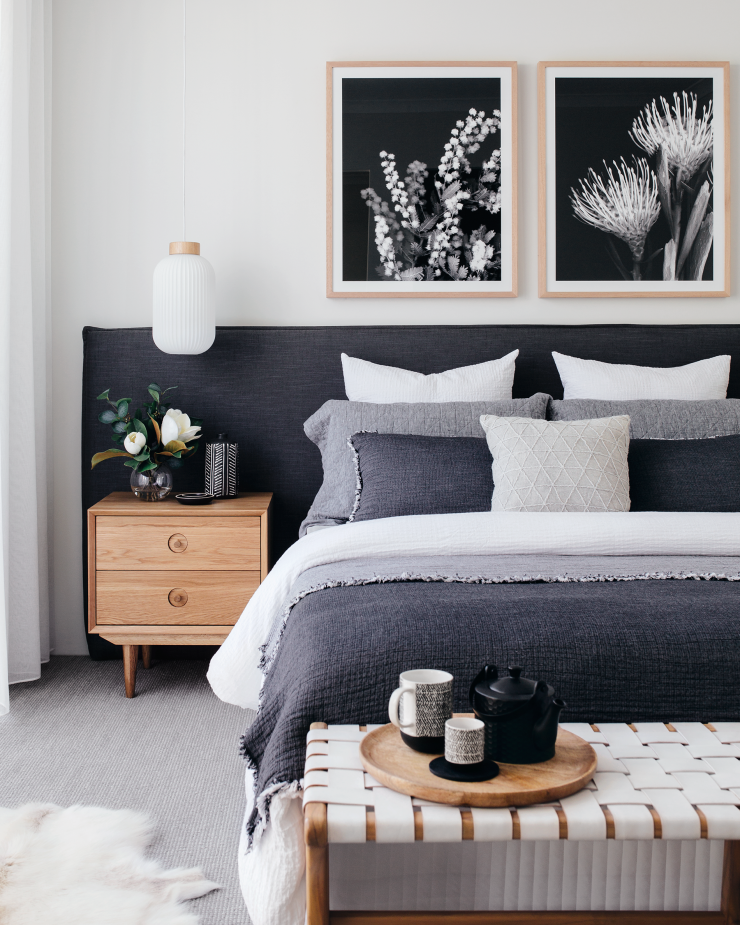 monochrome bedroom. Dark blue and grey bedding and features with light greys and whites