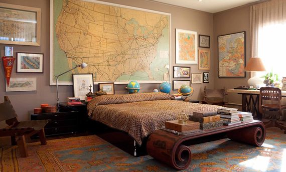 traveler themed bedroom. Large map of world on feature wall behind bed with other travelling themed items decorating the room