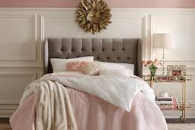 vintage glamour inspired bedroom. Basic layout with large headboard. Light pinks and whites used for colour theme with gold accents