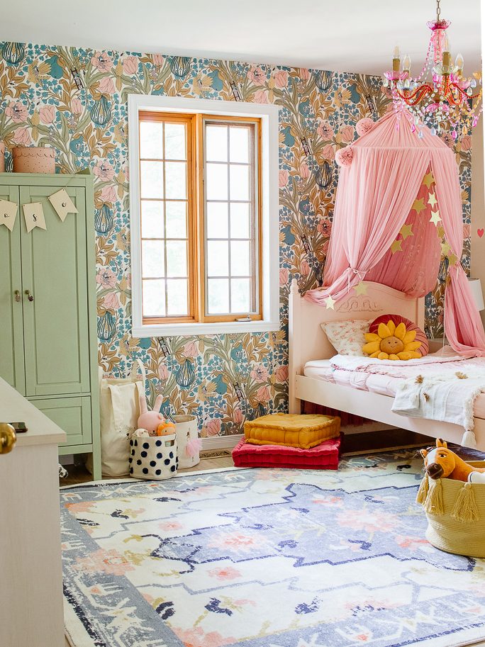 whimsical inspired bedroom. Lots of pinks and greens with patterned wall paper