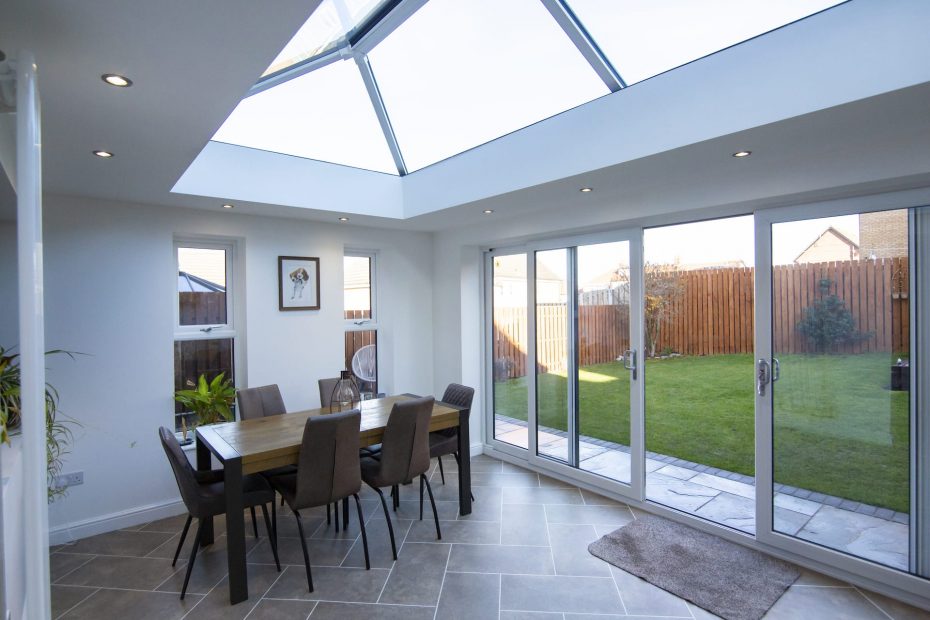 Extension with dining table with bifold doors and roof lantern
